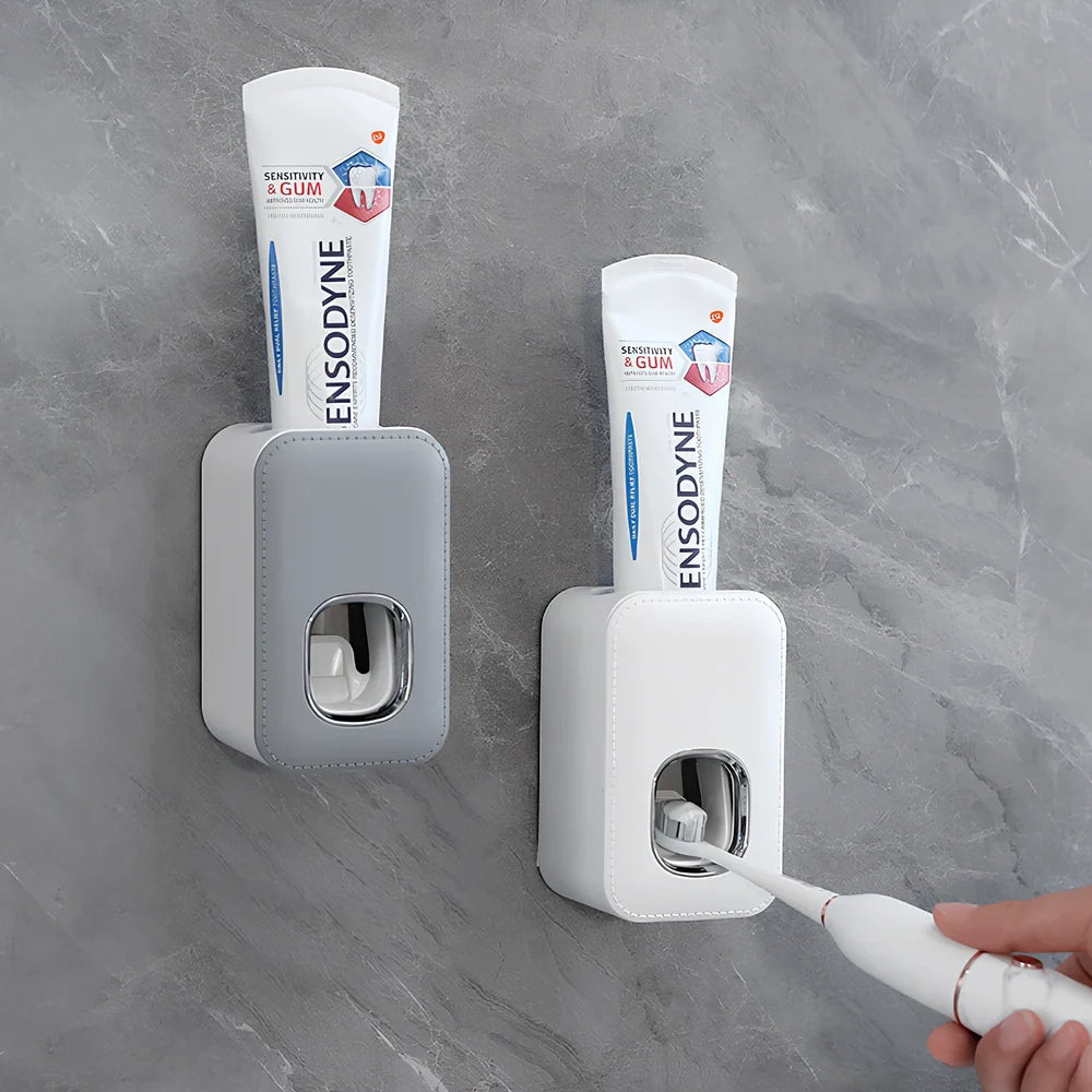 White automatic toothpaste dispenser mounted on bathroom wall with precise 0.8g portion dispensing