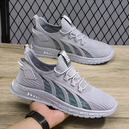 Low-top black mesh sneakers with a flat plastic sole and shallow cut design on a white background.