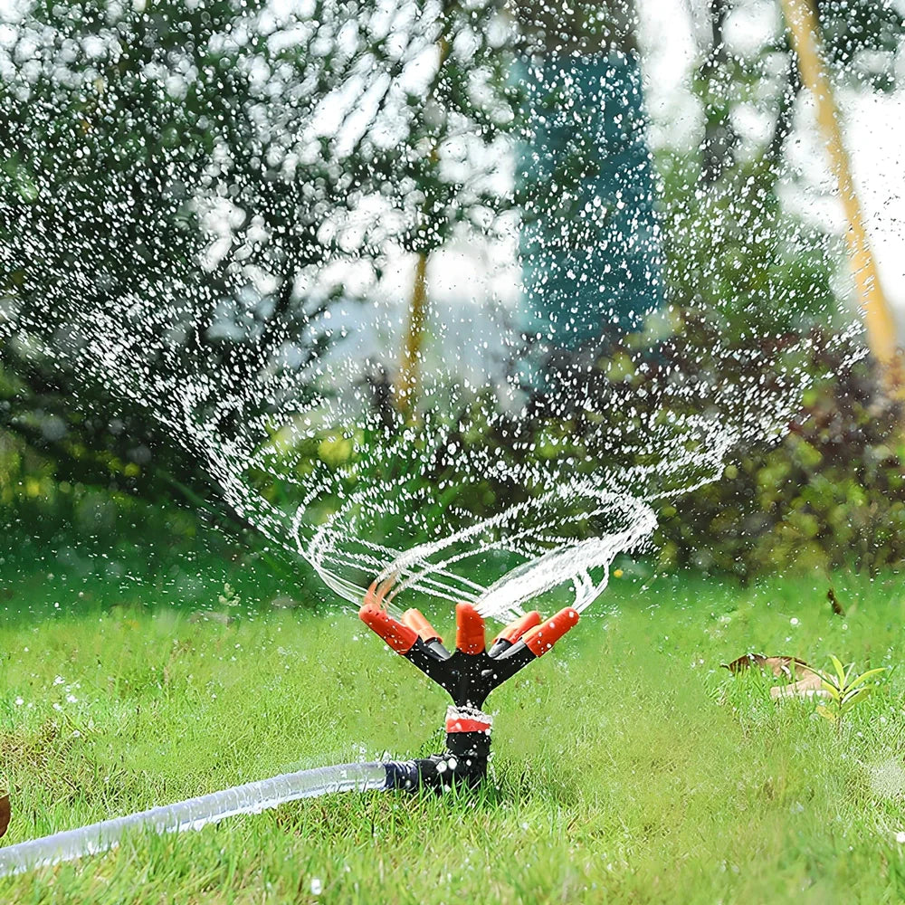 Orange automatic rotating garden sprinkler measuring 14cm diameter x 26.5cm height