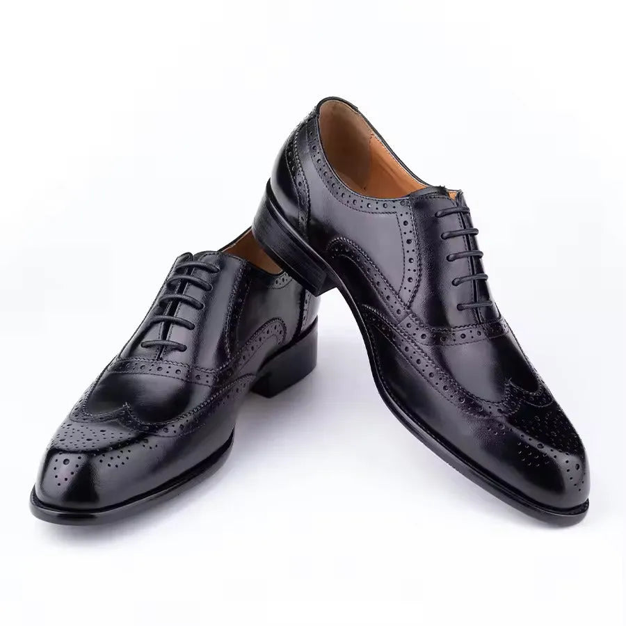 Men's purple leather Oxford shoes with hand-carved design and pointed toe on a rubber sole.
