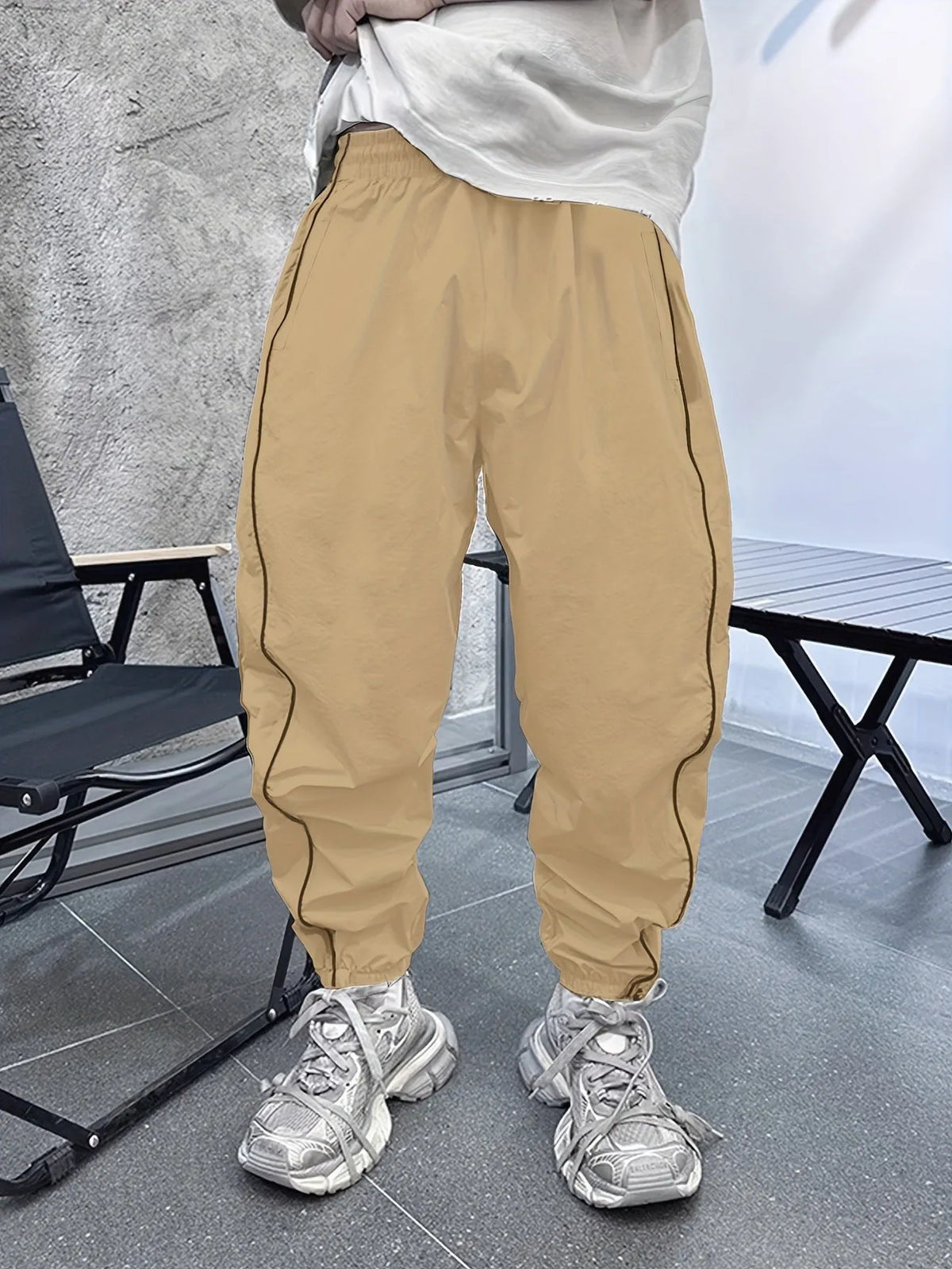 Men's bamboo fibre cropped sports trousers in army green colour showing loose fit and elastic waistband