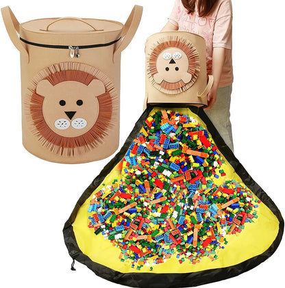 Green felt storage cube with pull rope unfolded into a large square play mat on a wooden floor.