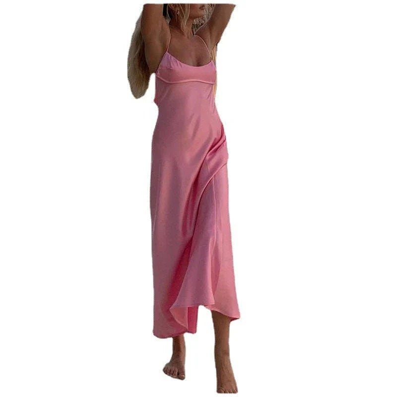 Elegant satin slip dress in pink with a flattering, form-fitting silhouette and sexy backless design