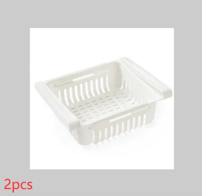 Plastic telescopic refrigerator storage basket in apricot colour, showing multiple compartments for organisation.