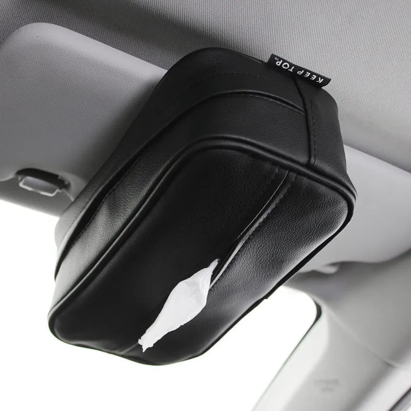 Black leather hanging storage box with PU coating, dimensions 23x13x9cm, shown behind a car headrest