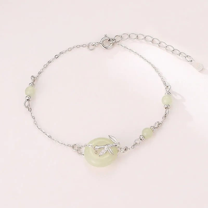 Close-up of a women's antique-style sterling silver bracelet with a peace buckle and safety clasp.