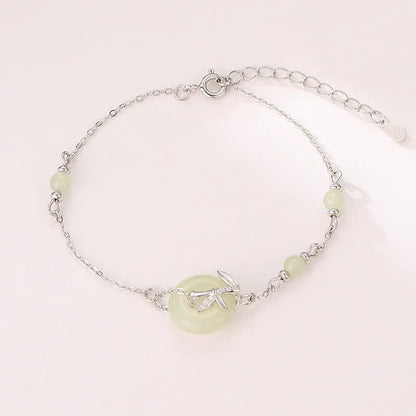 Close-up of a women's antique-style sterling silver bracelet with a peace buckle and safety clasp.