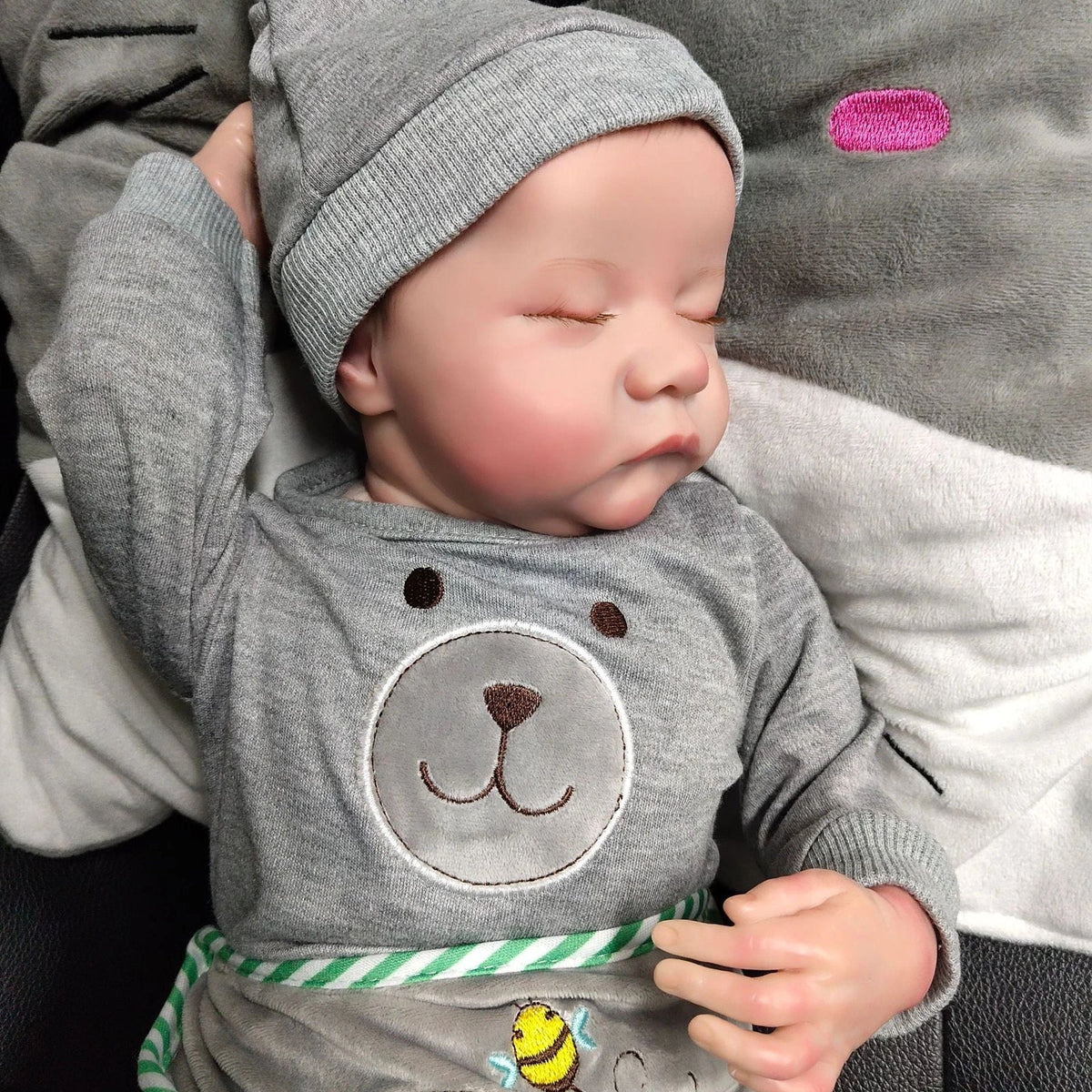 18-inch reborn doll with cloth body and hand-painted vinyl head wearing pink romper