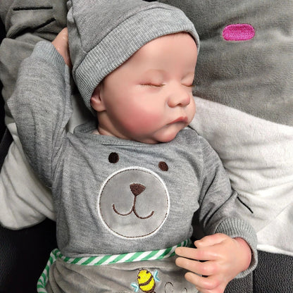 18-inch reborn doll with cloth body and hand-painted vinyl head wearing pink romper