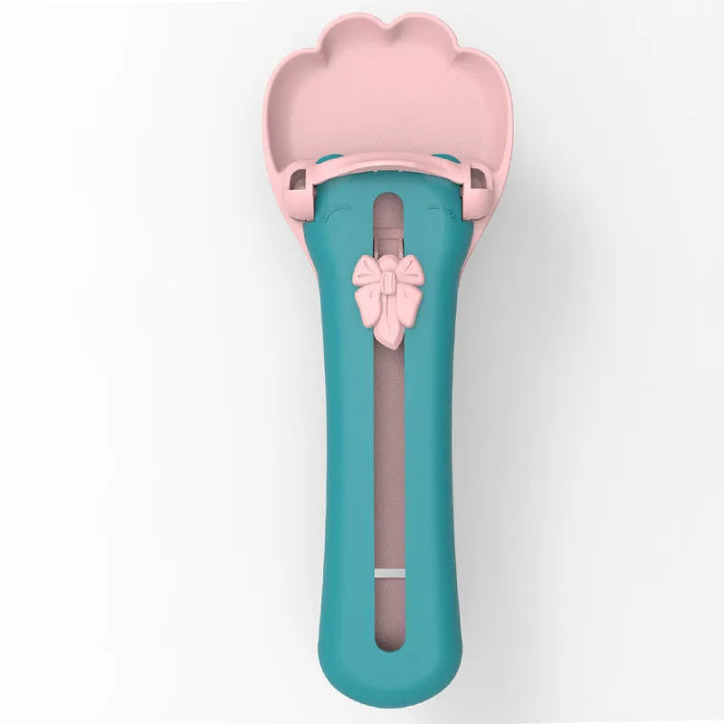 Green and pink pet food scoop and squeezer dispenser for cats and dogs.