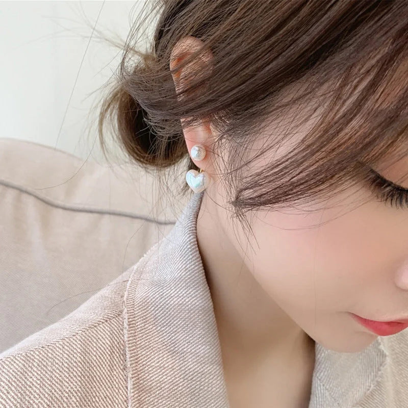Elegant heart-shaped pearl stud earrings for women, perfect for gifts or personal style.