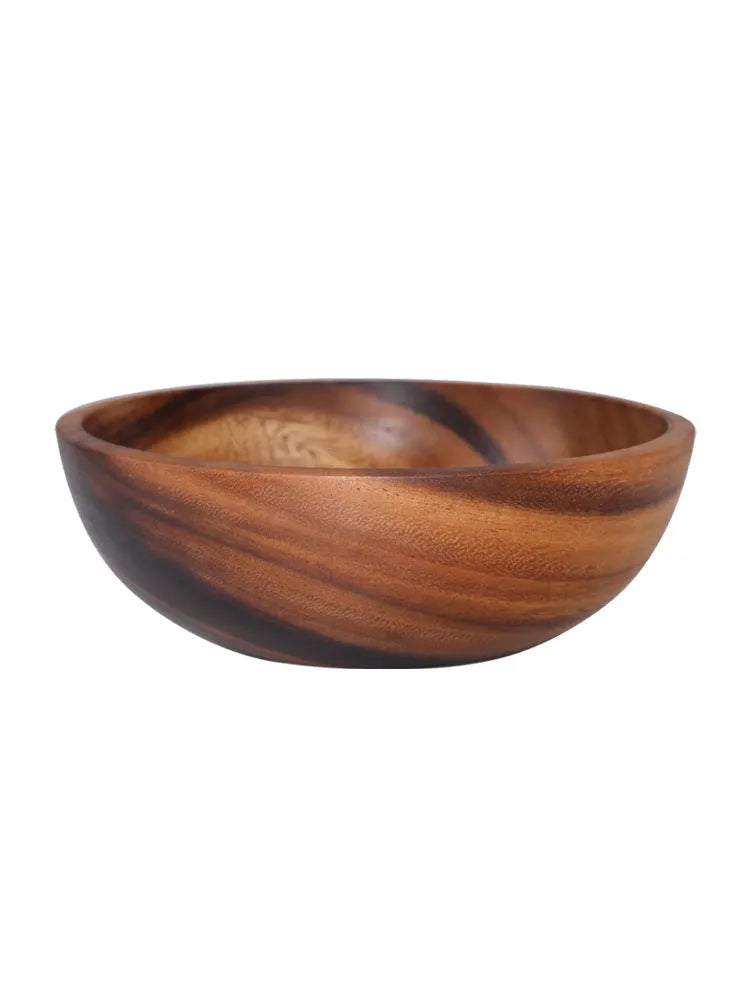 Brown handmade wooden serving bowl with natural wood grain on a table.