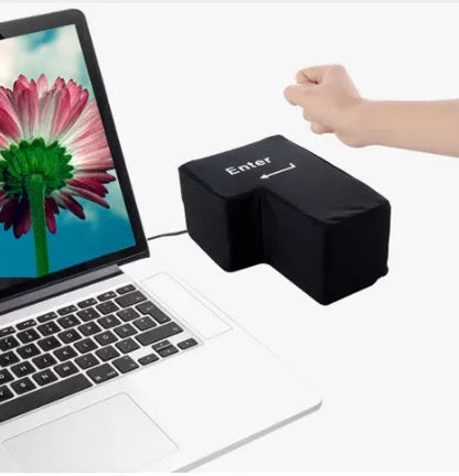 USB Decompression Enter Key Nap Pillow on a desk, showcasing its soft sponge material and USB cable.