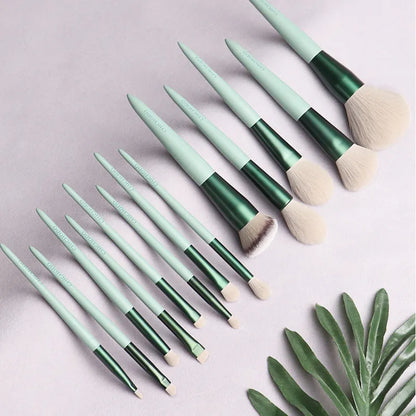 Green 13-piece makeup brush set with fibre wool bristles, metal aluminium ferrules and solid wood handles