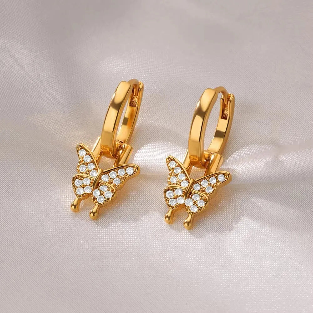 Women's irregular geometric butterfly earrings in copper with diamond treatment, showing heart-shaped and star designs in various colours