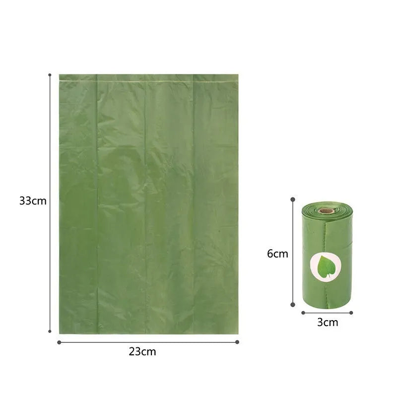 Roll of EPI green degradable pet waste bags next to a transparent dispenser on a grass background.