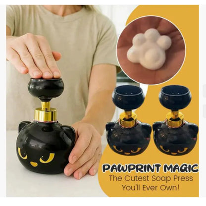 Black plastic cartoon cat-shaped manual soap dispenser on a countertop.