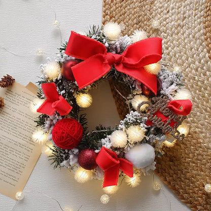 Multicolor Christmas LED light wreath with red berries, pine cones, and holly leaves