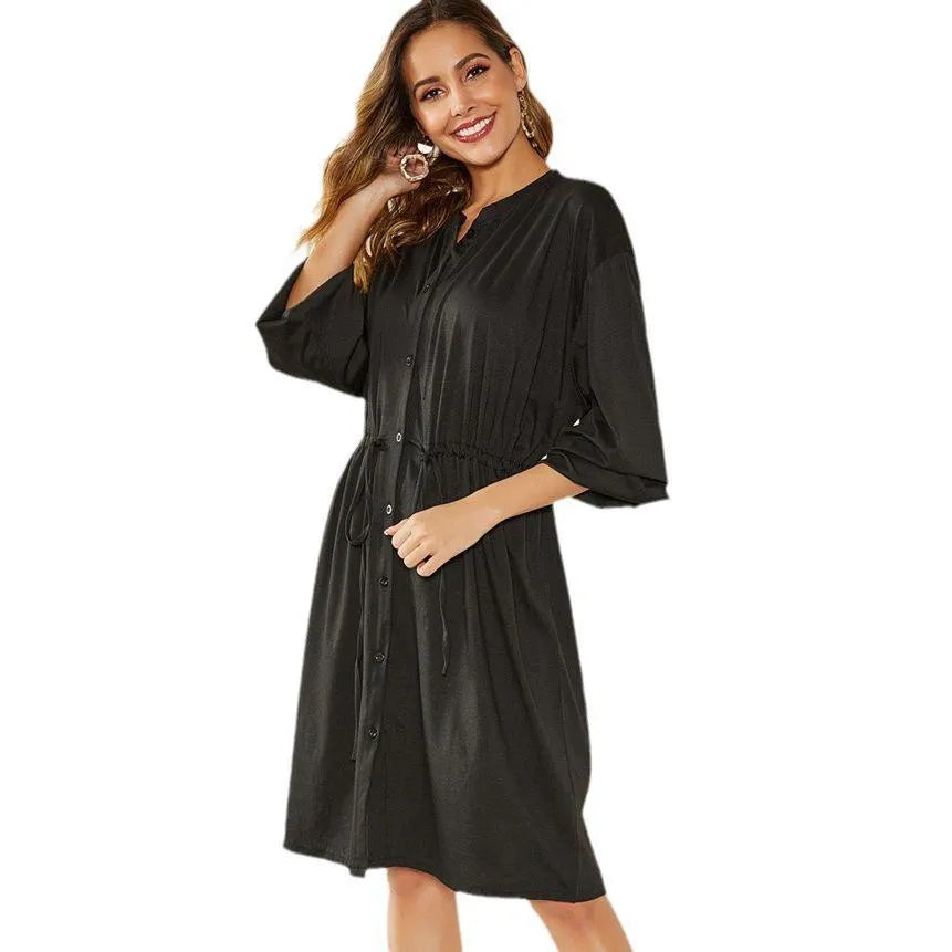 A-line mid-length dress with elastic waist, cinched belt, and long sleeves in solid black or red colour