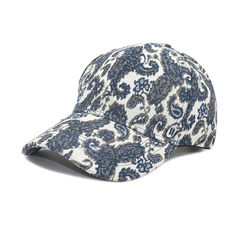 Blue polyester baseball cap with white paisley pattern print, showing dome crown style.