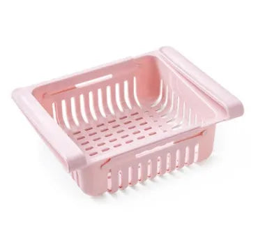 Plastic telescopic refrigerator storage basket in apricot colour, showing multiple compartments for organisation.