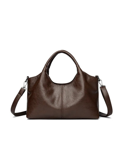 Soft genuine leather women's crossbody bag in beige with large capacity and adjustable strap.
