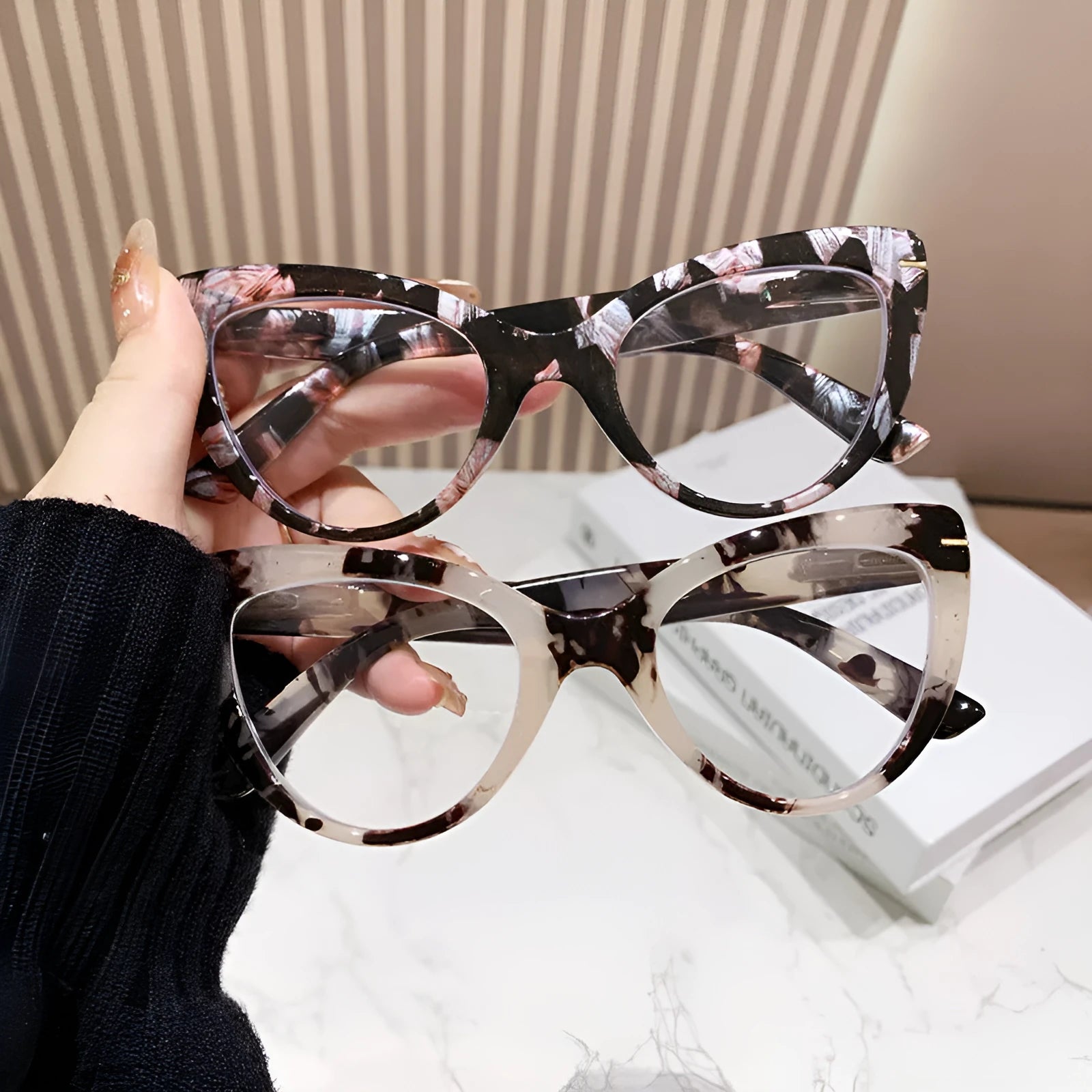 Women's black cat's eye reading glasses with gold dragon and phoenix decorations on the temples.