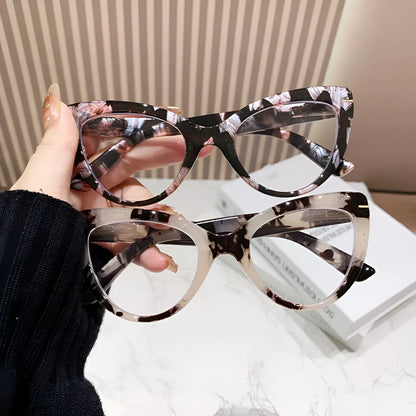 Women's black cat's eye reading glasses with gold dragon and phoenix decorations on the temples.