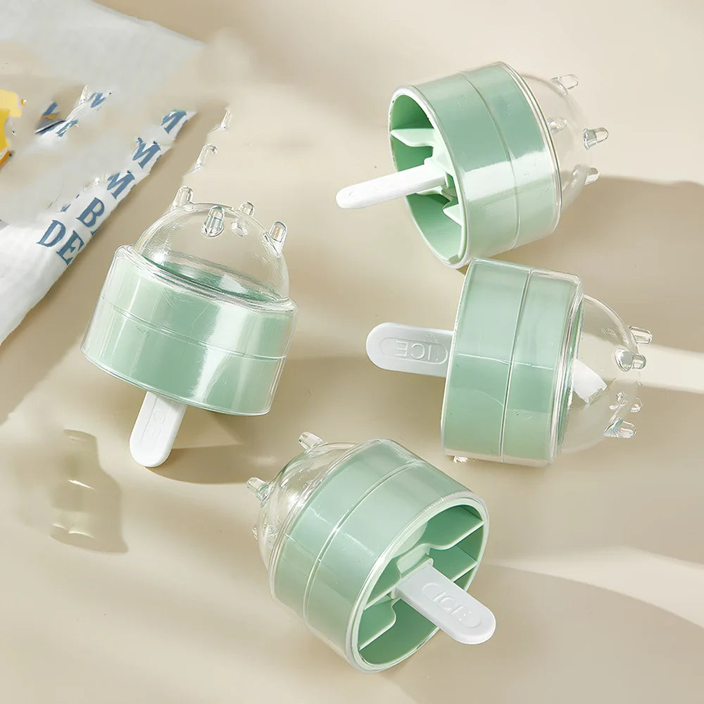 Four colourful lollipop-shaped silicone ice moulds showing creamy yellow, pink, blue, and yellow options