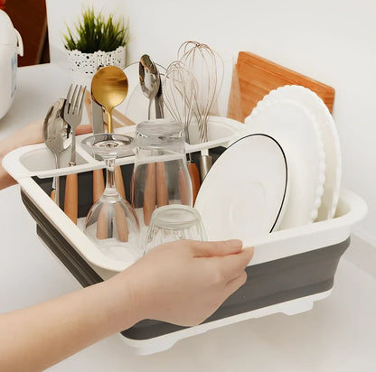 Grey folding kitchen dish rack showing collapsed flat position and separate utensil compartment