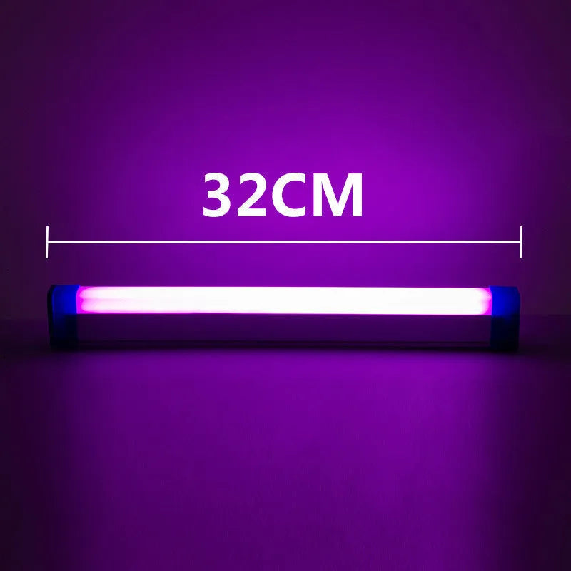 Blue rechargeable LED light tube with USB plug and push-button switch on a dark surface