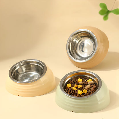 Single stainless steel cat bowl with a light green plastic base on a floor.