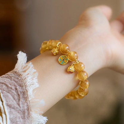 Handmade national style bracelet with coloured glaze swallowing gold beast charm on beaded band.