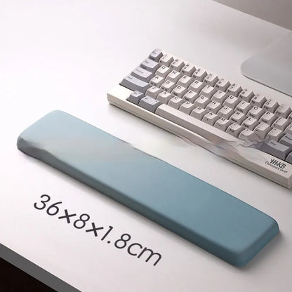 Square cloth mouse pad with grey silicone gel wrist rest and hand pillow on a wooden desk.