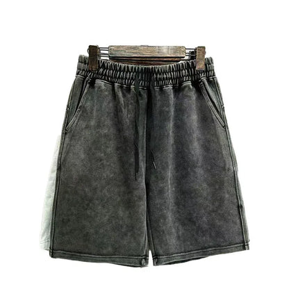Men's distressed light blue cotton shorts with a loose straight-leg casual fit on a neutral background