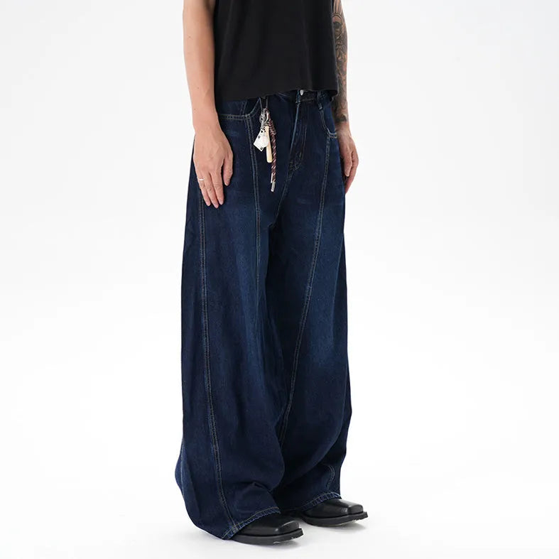 Woman wearing dark blue distressed wide leg denim jeans in a casual setting.