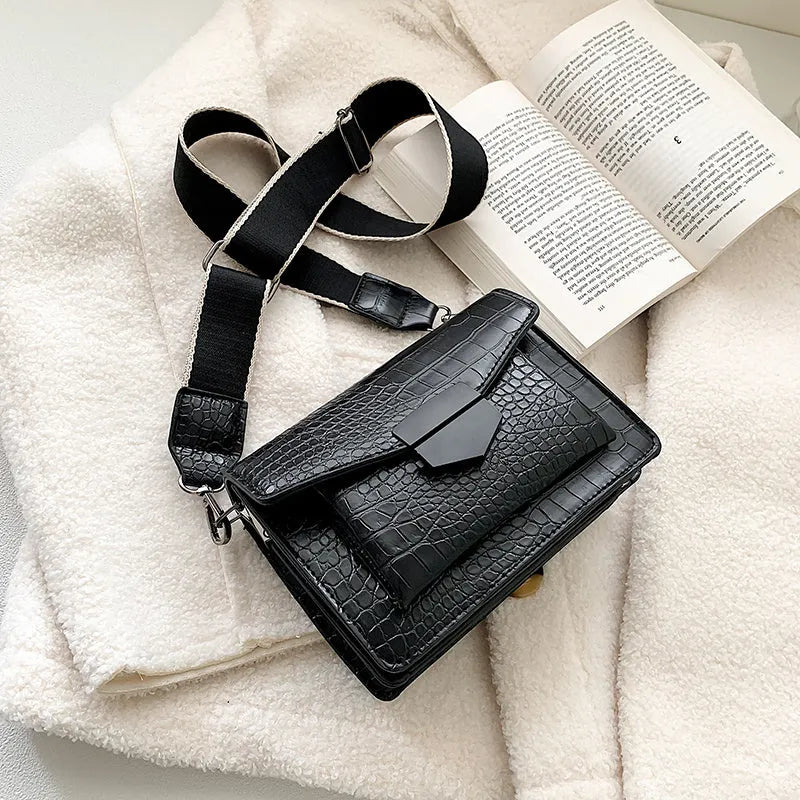 Vintage crossbody bag in black showing 20cm width, crossbody strap, and front storage compartment