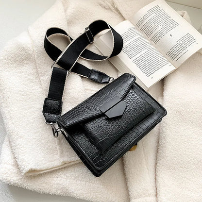 Vintage crossbody bag in black showing 20cm width, crossbody strap, and front storage compartment