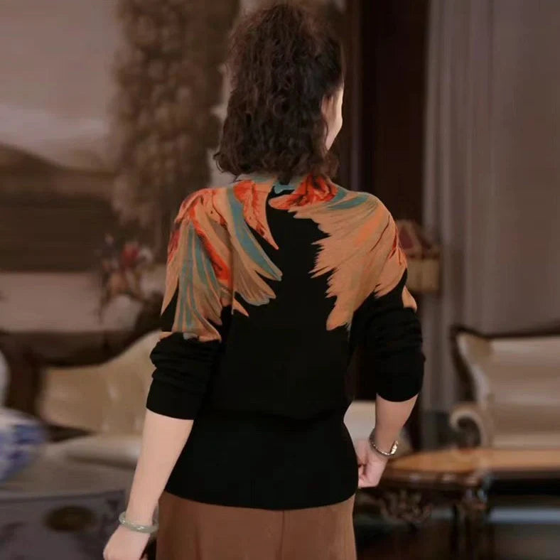 Black geometric floral pattern V-neck sweater with long sleeves and loose fit on hanger