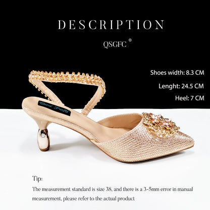 Women's black high-heel ankle strap shoes with floral rhinestone buckle and matching clutch bag on a neutral background