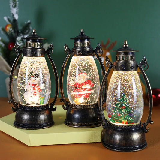 Crystal ball Christmas decoration with LED-lit paper snowman and elderly figures on desktop