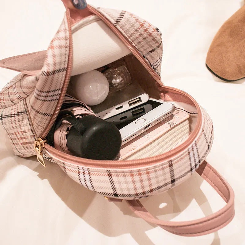 Black diagonal crossbody phone bag with adjustable strap and magnetic flap, shown on a model.