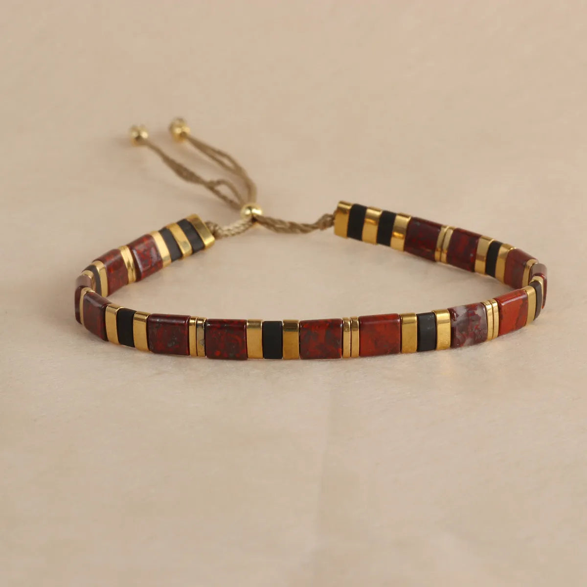 Adjustable pull beads glass bracelet in geometric shapes, shown in milky white colour.