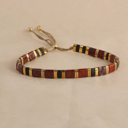 Adjustable pull beads glass bracelet in geometric shapes, shown in milky white colour.