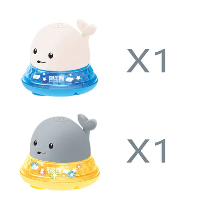 Automatic water-spraying whale bath toy with colourful lights floating in bath water.