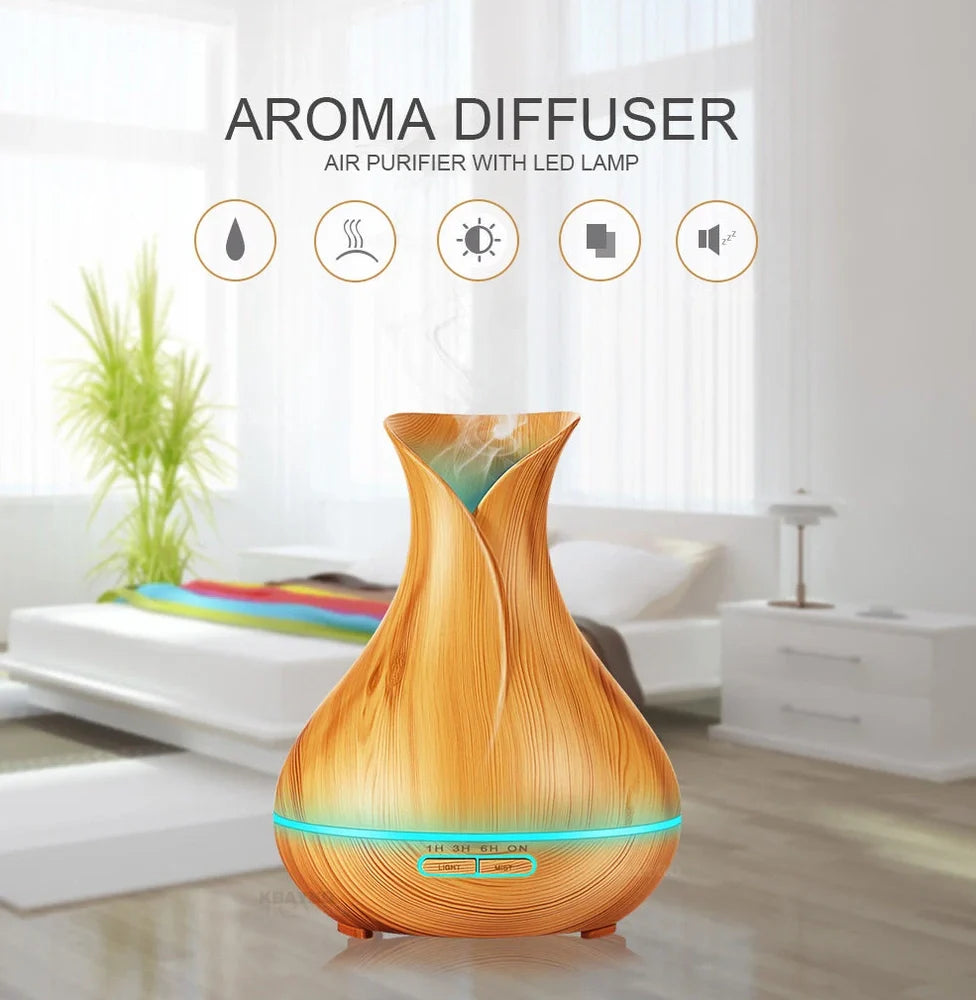 Black USB humidifier with colour-changing LED lights and water mist output, 15cm tall on wooden desk