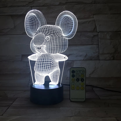 Black Koala night light with LED illumination on a bedside table.