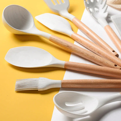 A set of silicone cooking utensils with sturdy wooden handles, designed to withstand high heat up to 446°F.