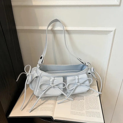 Women's tassel bow shoulder bag in pleated design with multiple pockets, shown in a selected colour.