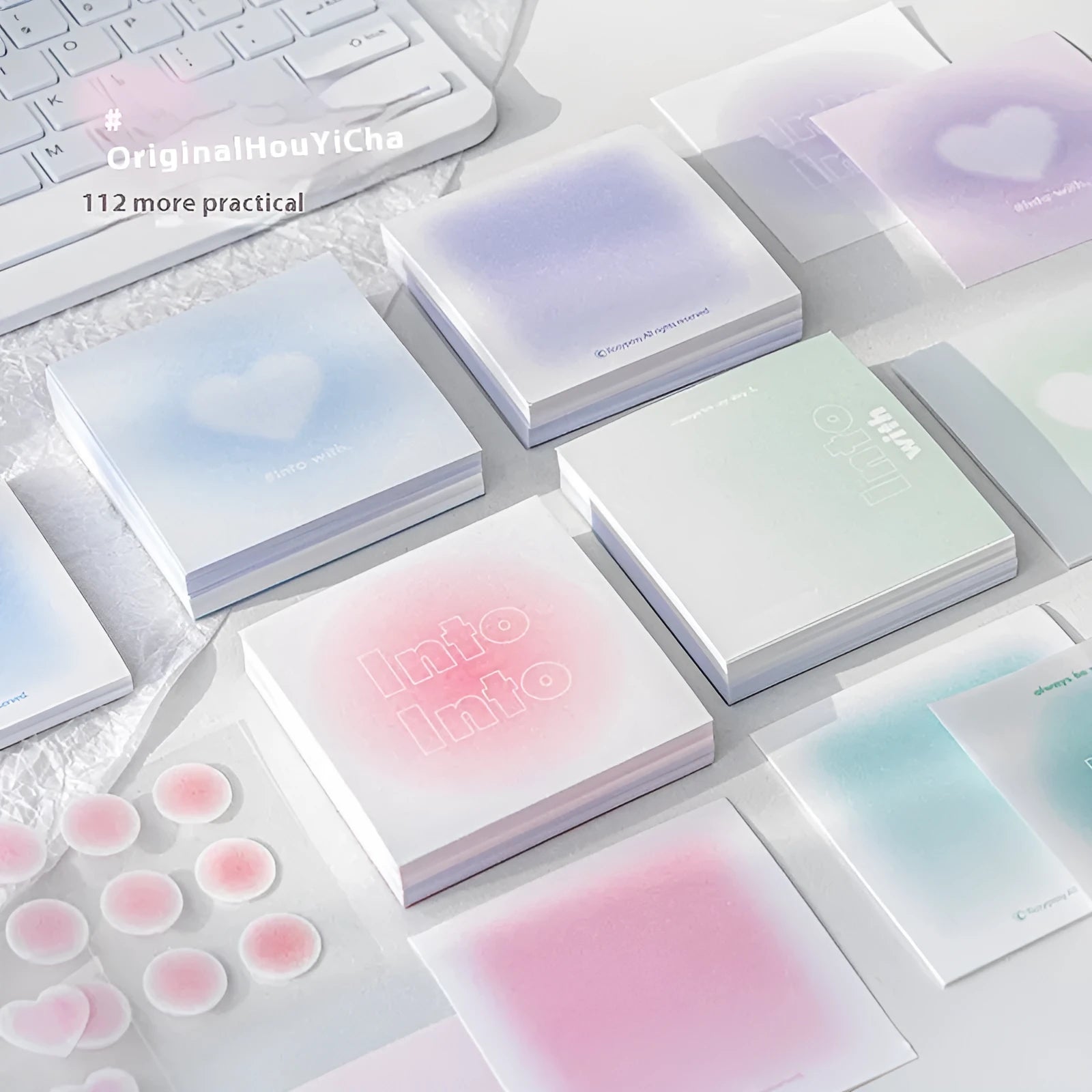 Square gradient-cover notepad showing pastel colours, open to reveal sticky notes, plain paper, and parchment sheets.